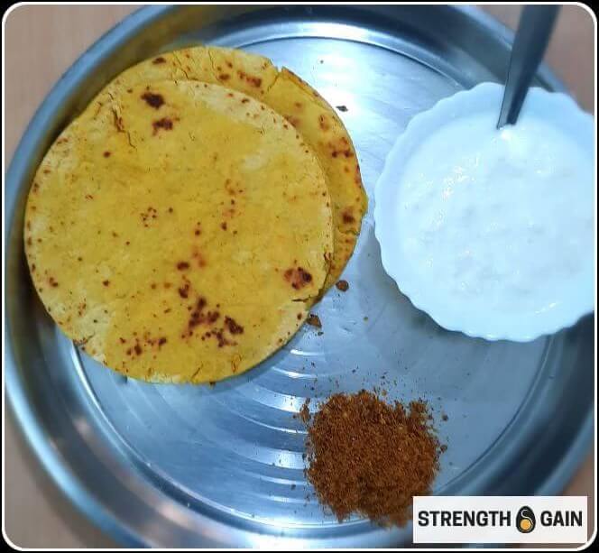 3 besan roti, 1 bowl curd and dry coconut chutney in a steel plate