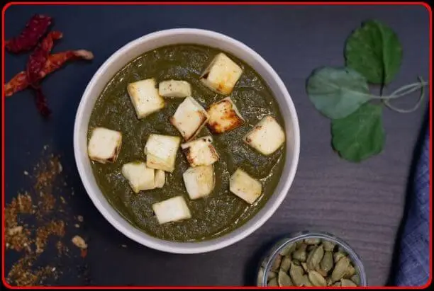 Palak paneer in a white bowl